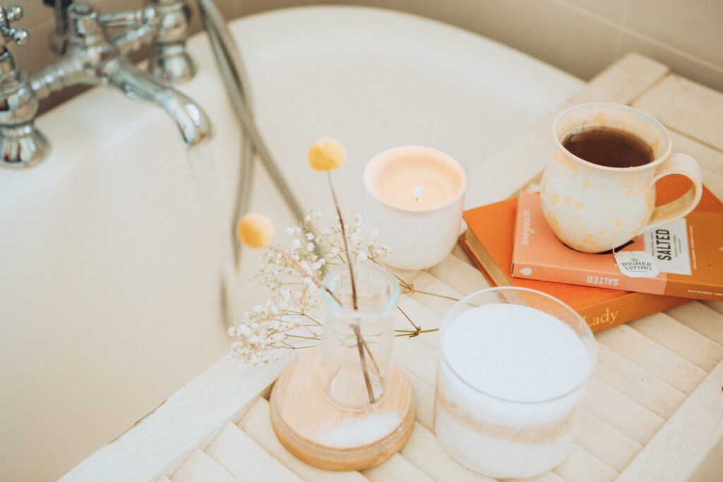 Ritual of drawing a bath and setting a relaxing stage with scented candles and a lovely cup of tea